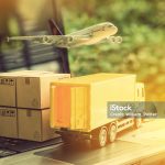 Air courier / freight forwarder or shipping service concept :  Boxes, a truck, white plane flies over a laptop, depicts customers order things from retailer sites via the internet and ship worldwide.